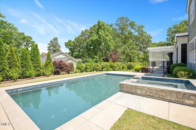 swimming pool featuring an in-ground hot tub