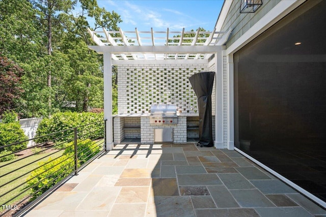 view of patio featuring an outdoor kitchen, area for grilling, and a pergola
