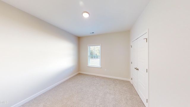 3725 Huntcliff Dr, La Grange, NC 28551 - unfurnished bedroom with a closet, baseboards, carpet flooring, and visible vents