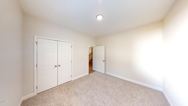 3725 Huntcliff Dr, La Grange, NC 28551 - unfurnished bedroom featuring carpet floors, baseboards, and a closet