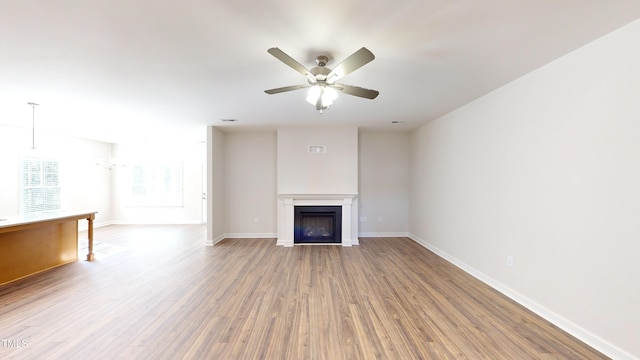 3725 Huntcliff Dr, La Grange, NC 28551 - unfurnished living room featuring baseboards, ceiling fan, wood finished floors, and a fireplace
