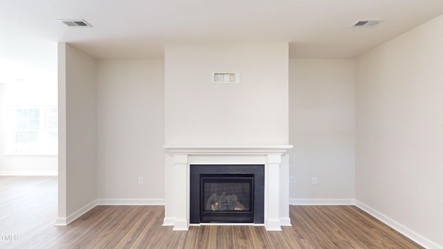3725 Huntcliff Dr, La Grange, NC 28551 - unfurnished living room featuring a glass covered fireplace, wood finished floors, and visible vents