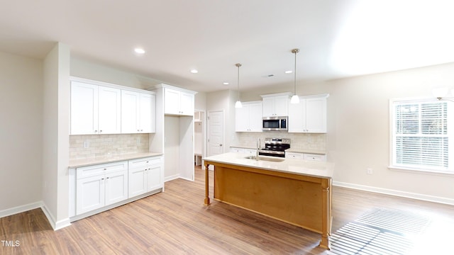 3725 Huntcliff Dr, La Grange, NC 28551 - kitchen featuring light wood-type flooring, light countertops, appliances with stainless steel finishes, and backsplash