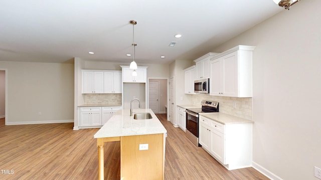 3725 Huntcliff Dr, La Grange, NC 28551 - kitchen with baseboards, a sink, light wood finished floors, backsplash, and stainless steel appliances