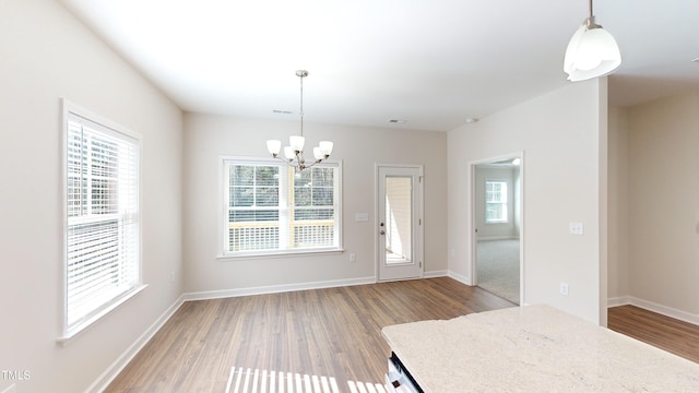 3725 Huntcliff Dr, La Grange, NC 28551 - unfurnished dining area with baseboards, visible vents, light wood-type flooring, and a chandelier