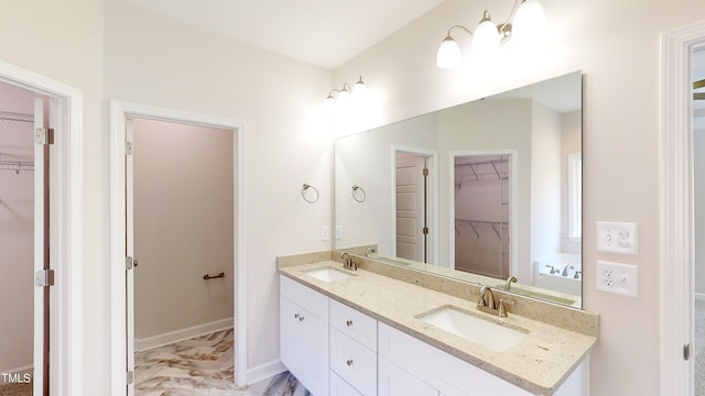 3725 Huntcliff Dr, La Grange, NC 28551 - bathroom featuring double vanity, a spacious closet, a sink, and marble finish floor