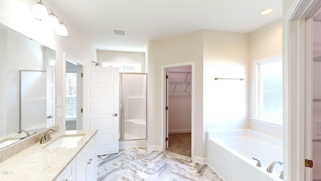 3725 Huntcliff Dr, La Grange, NC 28551 - bathroom featuring visible vents, a garden tub, vanity, a walk in closet, and a shower stall