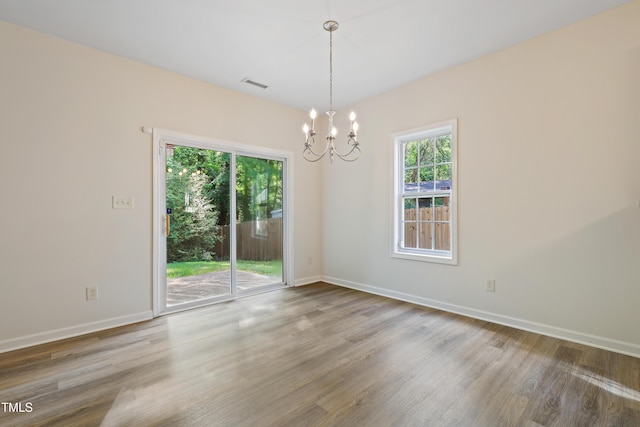 3223 Polite Ln, Raleigh, NC 27610 - empty room featuring a chandelier, wood finished floors, and baseboards