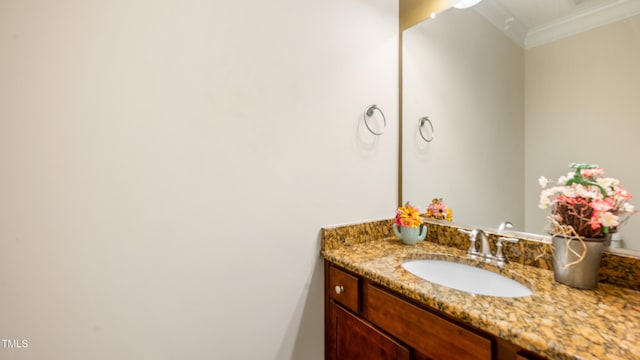 bathroom featuring vanity and ornamental molding