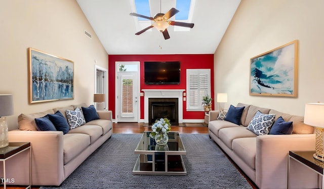 living area featuring a fireplace with flush hearth, ceiling fan, high vaulted ceiling, and visible vents