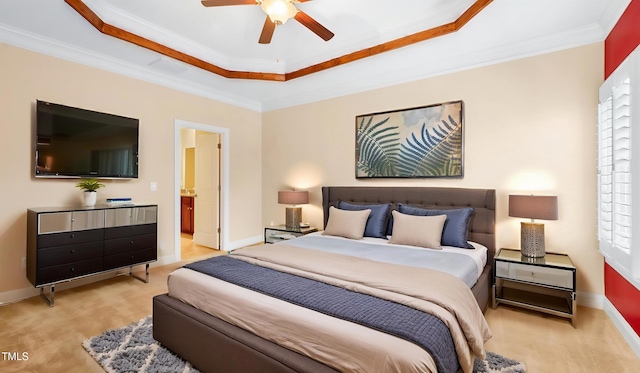 bedroom with baseboards, ornamental molding, a tray ceiling, and a ceiling fan