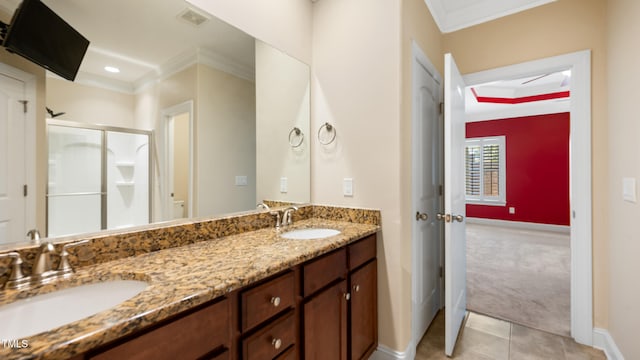 full bath with double vanity, baseboards, ornamental molding, and a sink