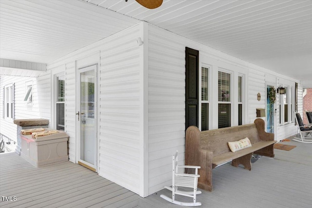 wooden deck featuring ceiling fan and covered porch