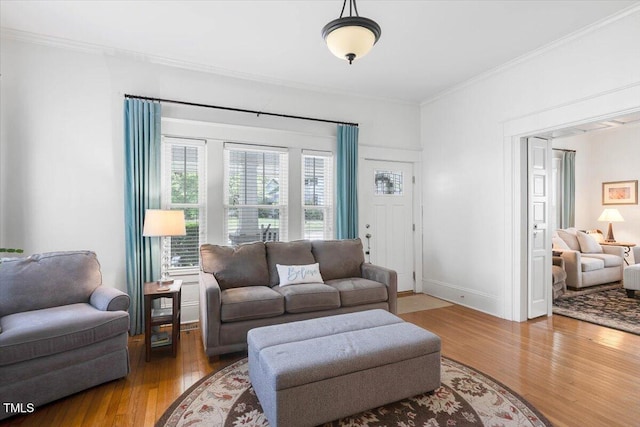 living room featuring ornamental molding and wood finished floors