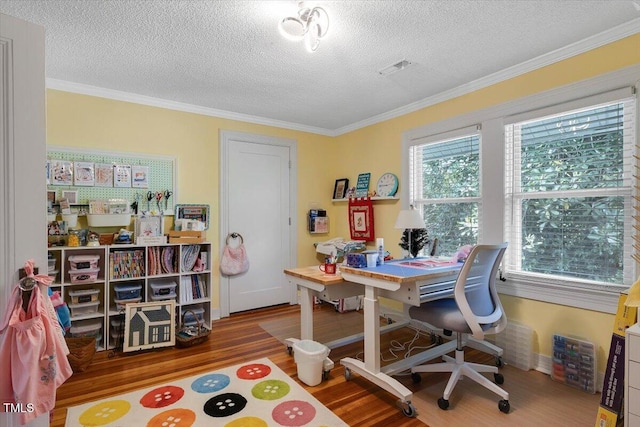 office area featuring baseboards, a textured ceiling, ornamental molding, and wood finished floors
