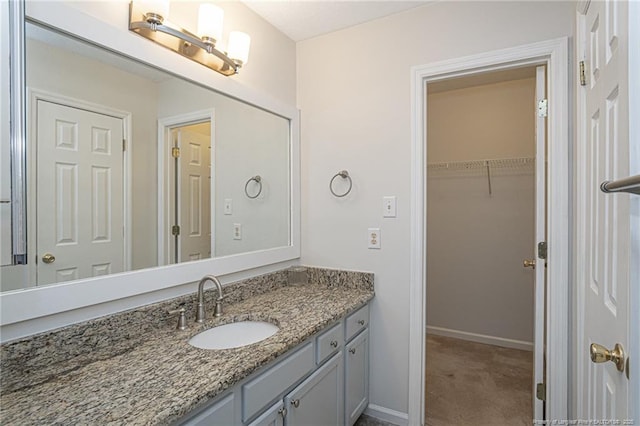 bathroom featuring vanity and baseboards
