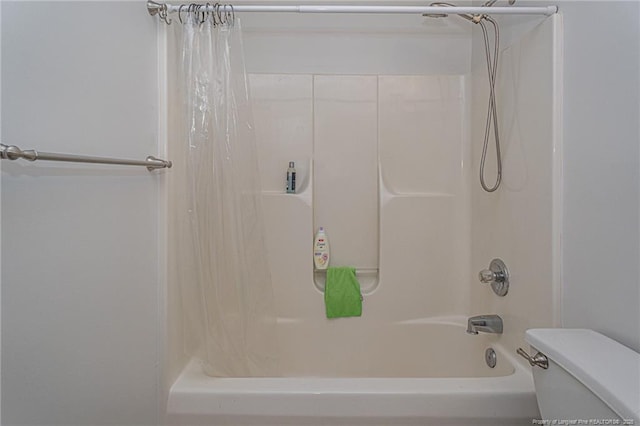 bathroom featuring shower / bath combo with shower curtain and toilet