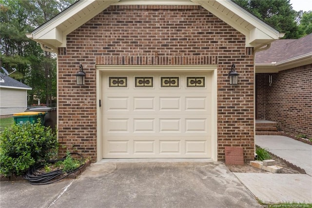 garage featuring concrete driveway