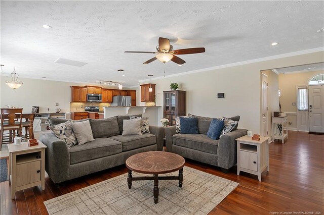living area with crown molding, ceiling fan, recessed lighting, a textured ceiling, and dark wood finished floors