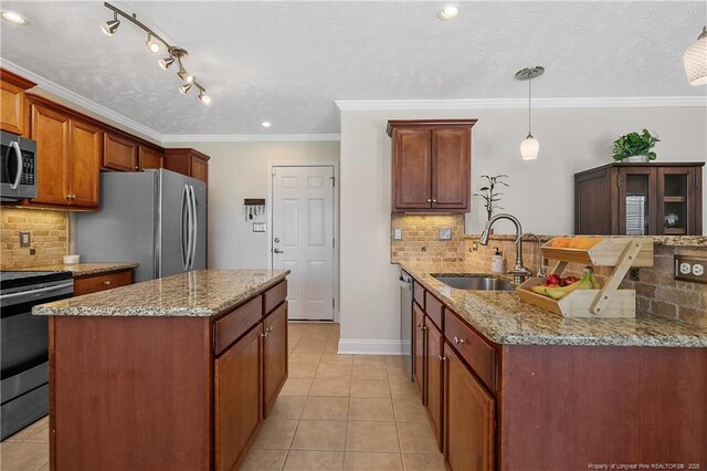 kitchen with a sink, tasteful backsplash, stainless steel appliances, and light tile patterned flooring