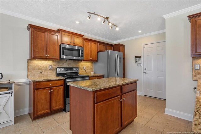 kitchen with light tile patterned floors, appliances with stainless steel finishes, backsplash, and light stone counters