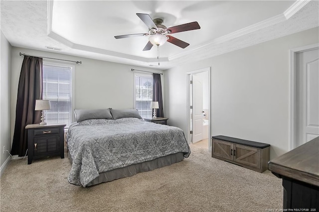 bedroom featuring ceiling fan, visible vents, a raised ceiling, ornamental molding, and light carpet
