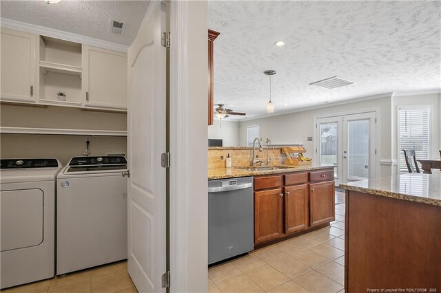 kitchen with visible vents, light tile patterned flooring, separate washer and dryer, a sink, and dishwasher