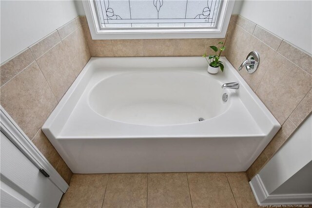 full bathroom featuring tile patterned flooring and a bath