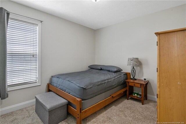 carpeted bedroom with baseboards
