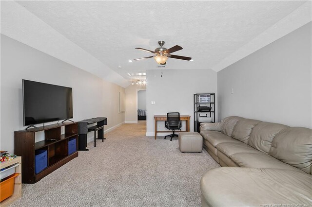 living area with light colored carpet, a ceiling fan, and baseboards