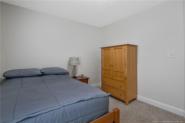 bedroom featuring baseboards and carpet floors
