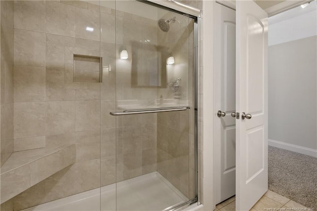 bathroom featuring a shower stall and tile patterned flooring