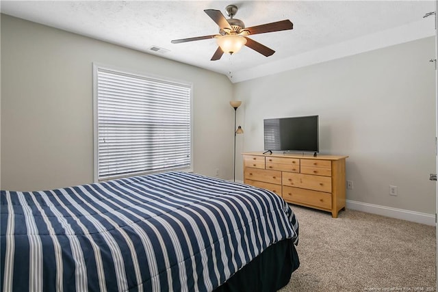 bedroom featuring visible vents, a ceiling fan, baseboards, and light carpet