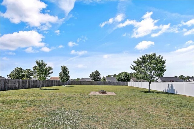 view of yard featuring a fenced backyard and an outdoor fire pit