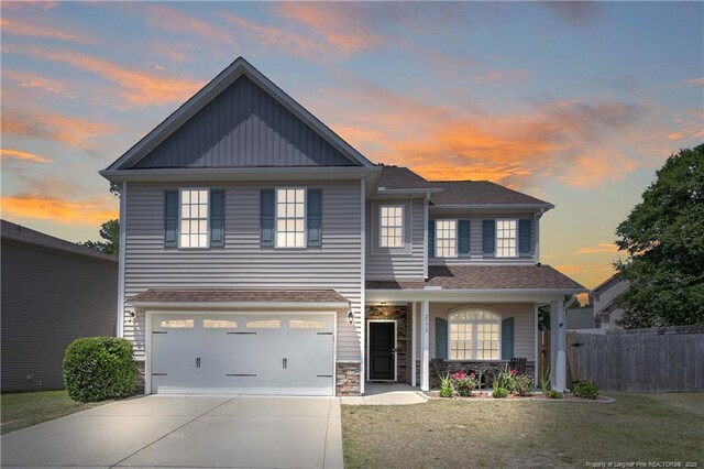2772 Mosquera Dr, Fayetteville, NC 28306 - view of front of home featuring a garage, fence, concrete driveway, a porch, and a yard