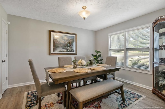 4631 Cedar Pass Dr, Hope Mills, NC 28348 - dining area featuring baseboards, a textured ceiling, and light wood-style flooring