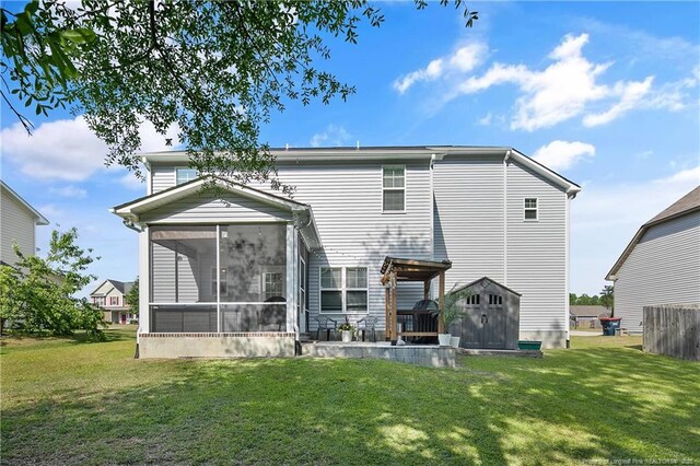 4631 Cedar Pass Dr, Hope Mills, NC 28348 - rear view of property with an outdoor structure, a sunroom, a shed, a lawn, and a patio