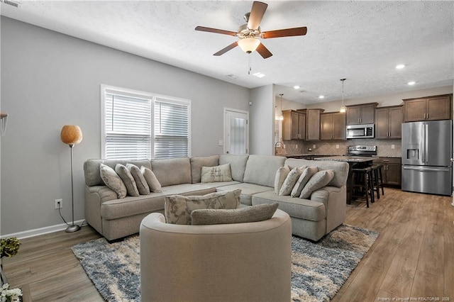 4631 Cedar Pass Dr, Hope Mills, NC 28348 - living area with recessed lighting, light wood finished floors, ceiling fan, and baseboards