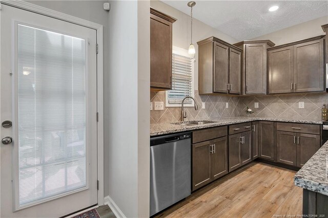 4631 Cedar Pass Dr, Hope Mills, NC 28348 - kitchen with light stone counters, a sink, decorative backsplash, light wood-type flooring, and stainless steel dishwasher
