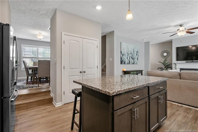 4631 Cedar Pass Dr, Hope Mills, NC 28348 - kitchen featuring freestanding refrigerator, a ceiling fan, a textured ceiling, and light wood-style flooring