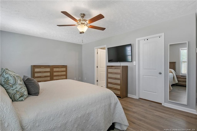 4631 Cedar Pass Dr, Hope Mills, NC 28348 - bedroom with a textured ceiling, baseboards, a ceiling fan, and wood finished floors