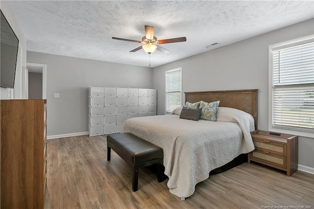 4631 Cedar Pass Dr, Hope Mills, NC 28348 - bedroom featuring visible vents, a textured ceiling, baseboards, and wood finished floors