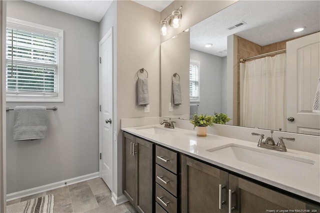 4631 Cedar Pass Dr, Hope Mills, NC 28348 - full bathroom featuring visible vents, a sink, baseboards, and double vanity