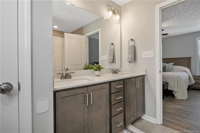4631 Cedar Pass Dr, Hope Mills, NC 28348 - full bath featuring connected bathroom, a textured ceiling, baseboards, and a sink