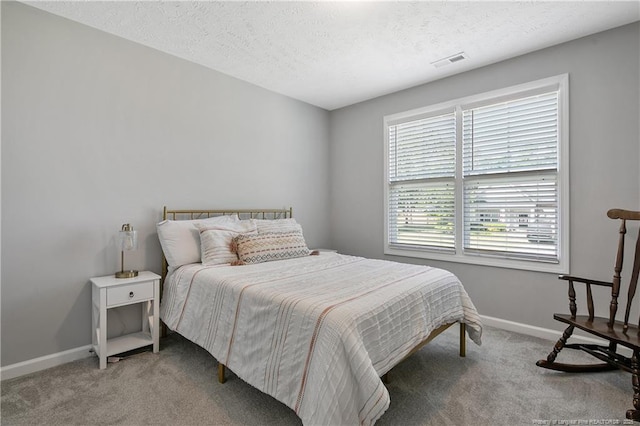 4631 Cedar Pass Dr, Hope Mills, NC 28348 - carpeted bedroom featuring a textured ceiling, visible vents, and baseboards