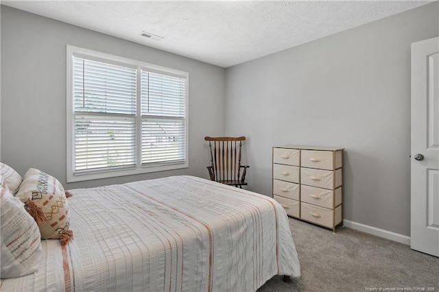 4631 Cedar Pass Dr, Hope Mills, NC 28348 - carpeted bedroom featuring baseboards, a textured ceiling, and visible vents