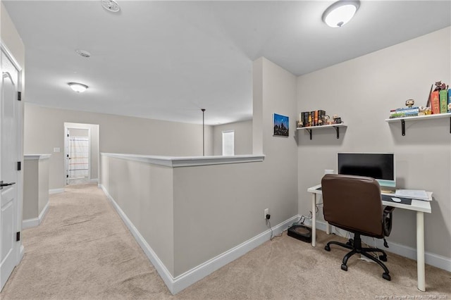 carpeted home office featuring baseboards