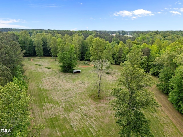 birds eye view of property with a view of trees and a rural view