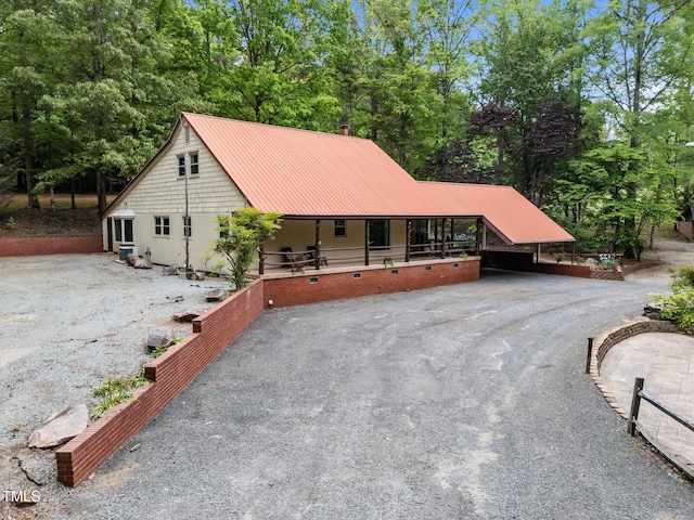 view of front of house with metal roof and aphalt driveway