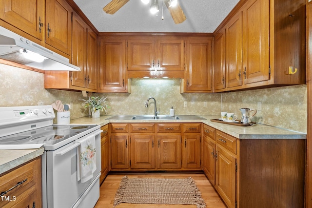 kitchen with brown cabinets and white range with electric cooktop